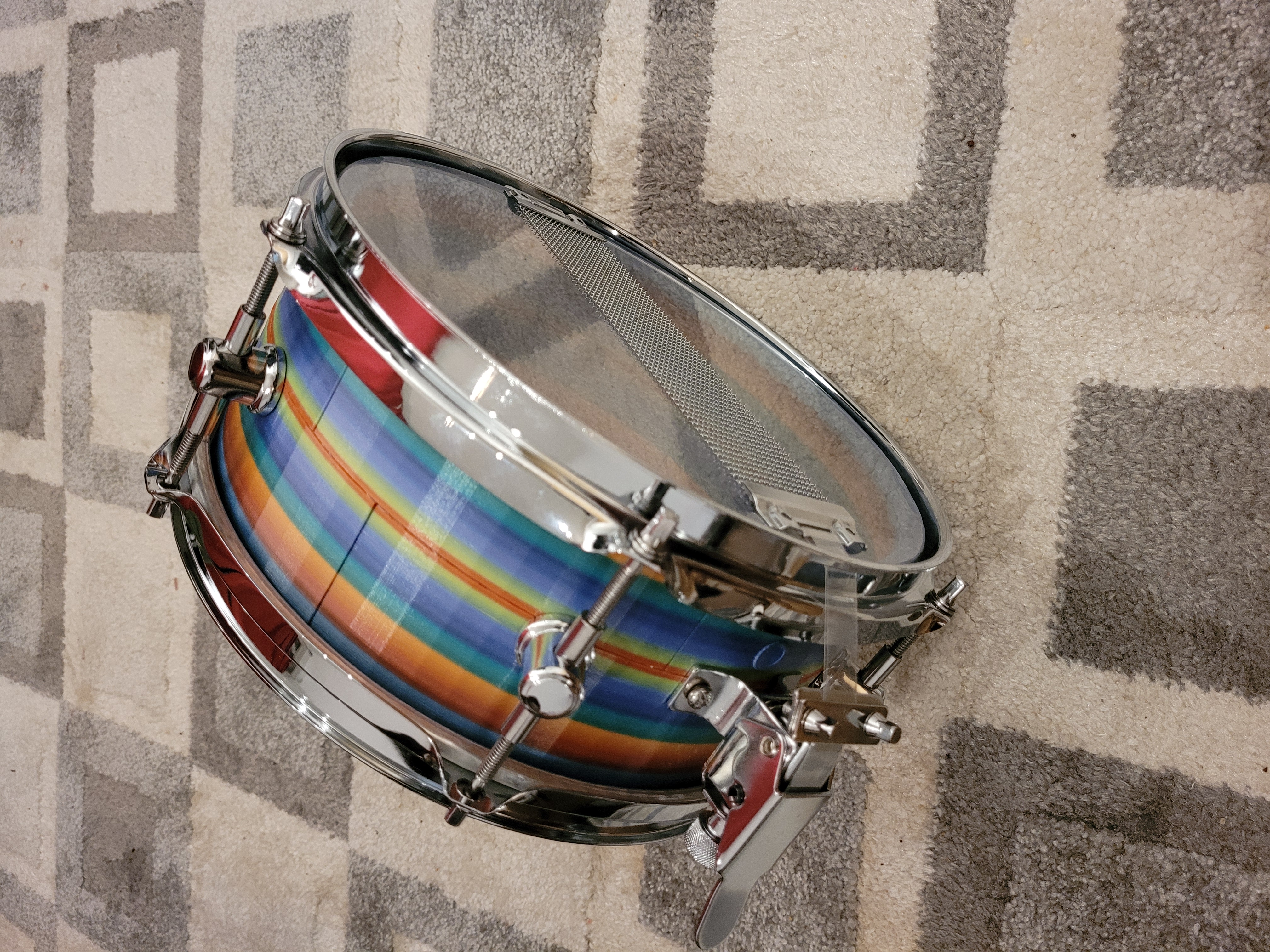 First assembled Falcon Drums prototype — side view showing vivid rainbow-layered shell
